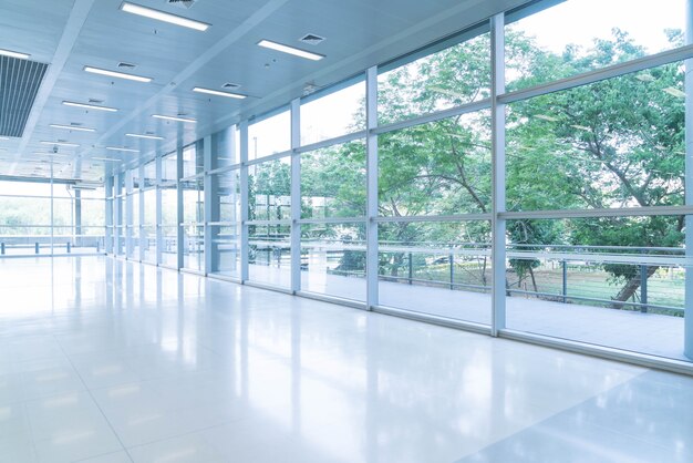 Blurred abstract background interior view looking out toward to empty office lobby and entrance doors and glass curtain wall with frame