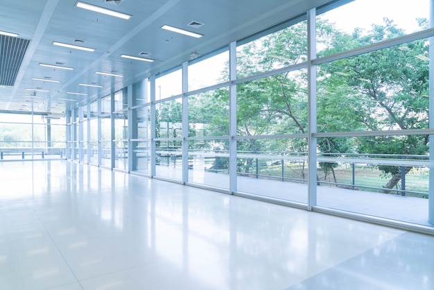 Blurred abstract background interior view looking out toward to empty office lobby and entrance doors and glass curtain wall with frame