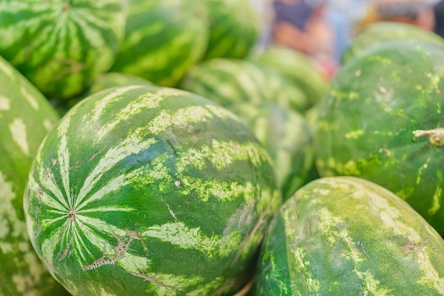 Blurred background of watermelons in the market background and screensaver idea for advertising or seasonal products store