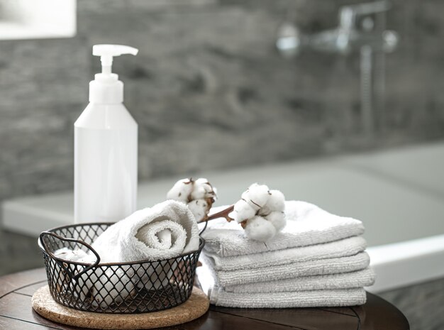 Blurred bathroom interior and set of clean folded towels copy space. Hygiene and health concept.