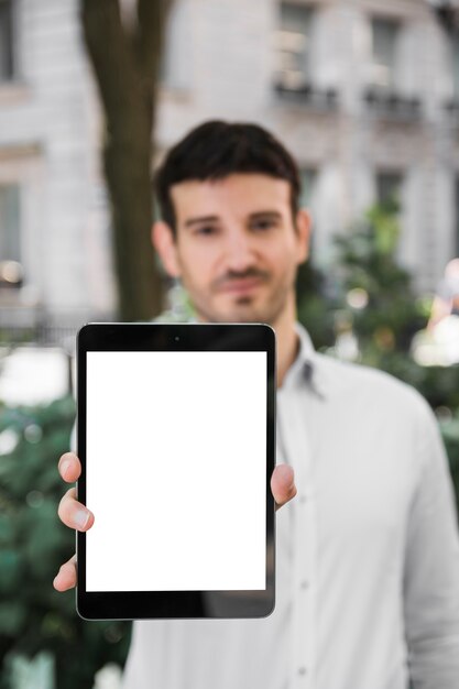 Blurred businessman demonstrating tablet