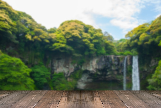 Blurred Cheonjiyeon Waterfall is a waterfall on Jeju Island, South Korea with wooden bridge.