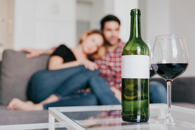 Blurred couple at table with wine