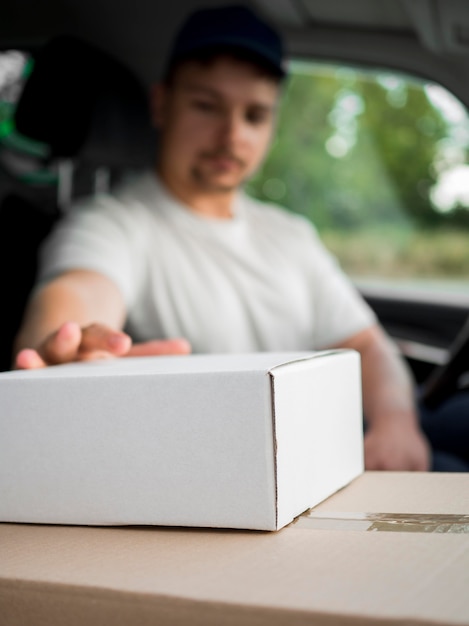 Blurred delivery man in car