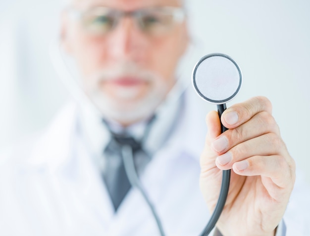Blurred doctor showing stethoscope