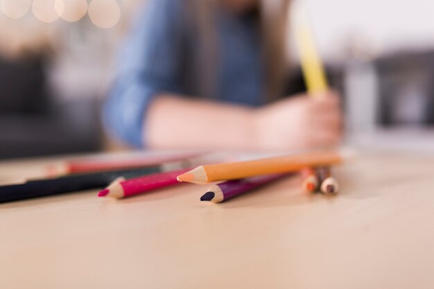 Blurred image of girl drawing