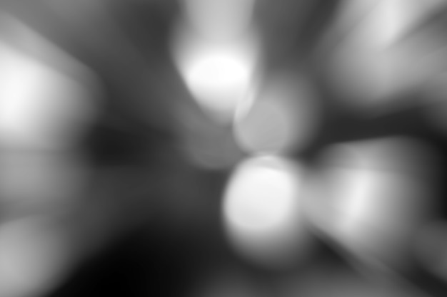 ぼやけた​ライト​の​暗い​灰色​の​背景​。​抽象的​な​ソフト​爆発​効果​。​中心​運動​パターン