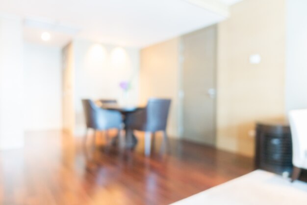 Blurred living room with black chairs and wooden floor