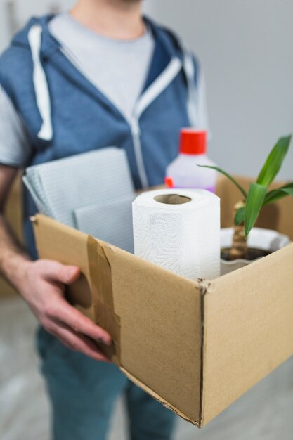 Blurred man holding box with things