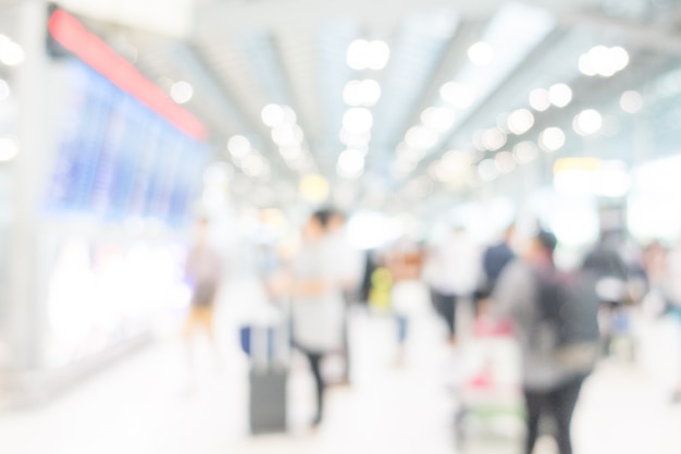 Blurred people watching the screens with flights