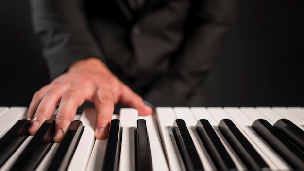 Free photo blurred person playing digital piano