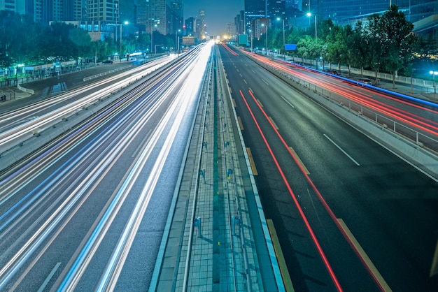 blurred traffic light trails on road at night