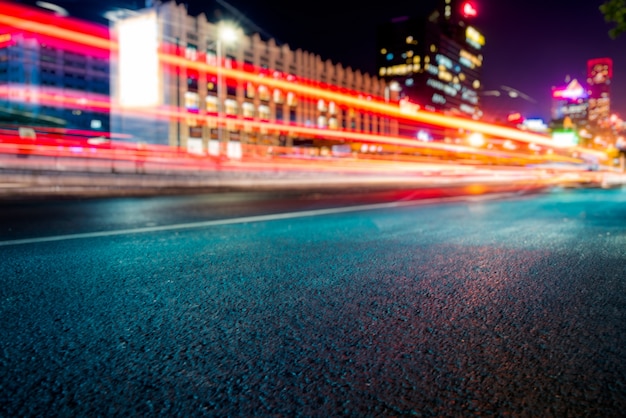 blurred traffic light trails on road at night