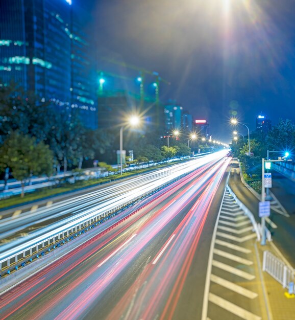 blurred traffic light trails on road at night