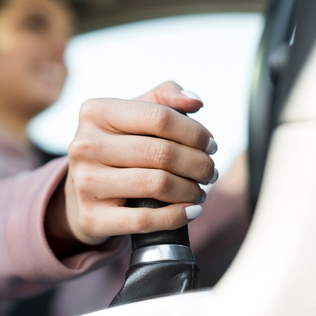 Blurred woman driver changing the gears