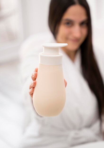 Blurred woman holding bottle