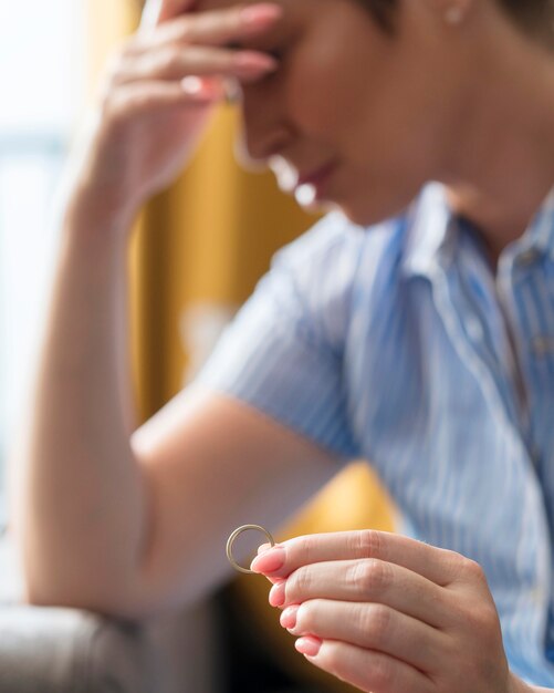 Blurred woman holding wedding ring