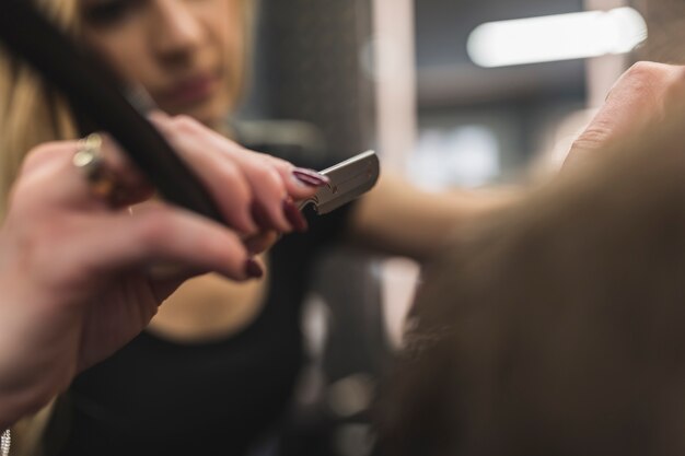 Blurred woman shaving man