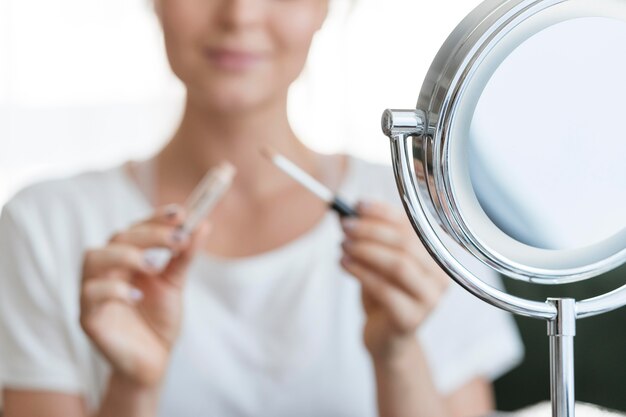 Blurred woman with make-up and mirror