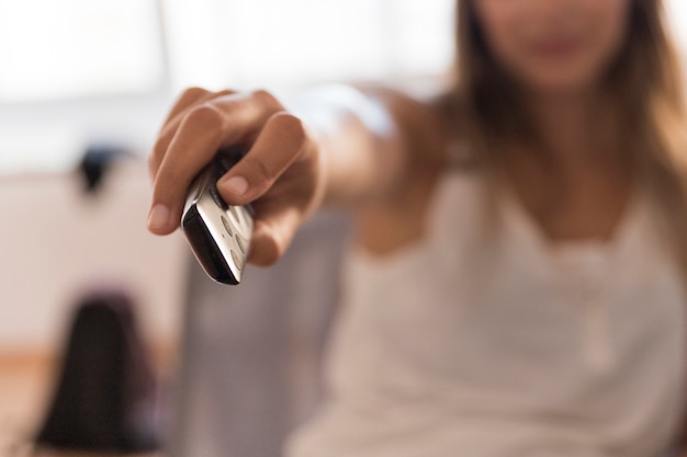 Blurred woman with remote control