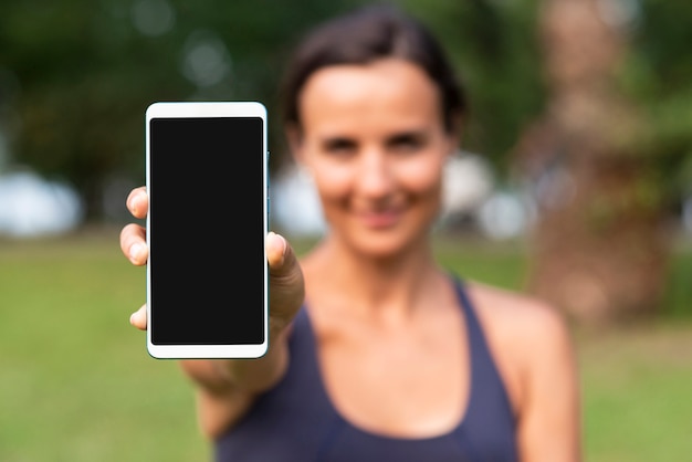 Free photo blurred woman with smartphone mock-up