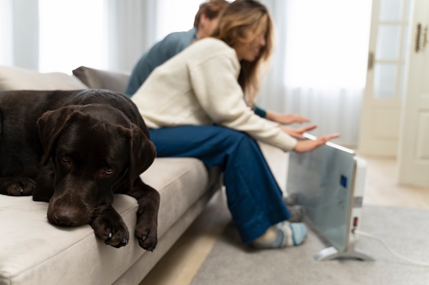 Free photo blurry couple warming up with heater at home