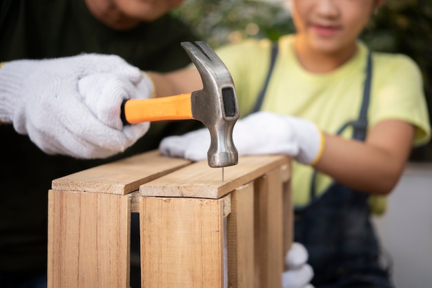 Blurry father and girl using hammer