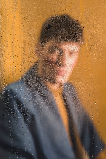 Blurry portrait of man looking at camera