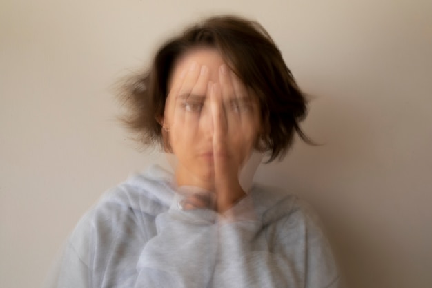 Blurry woman dealing with anxiety front view