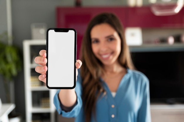 Blurry woman holding phone medium shot