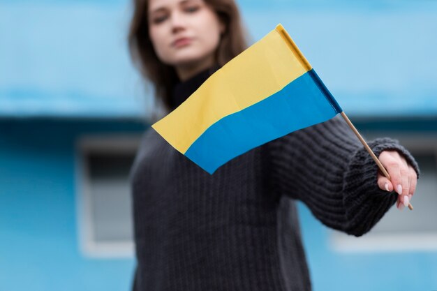 Blurry woman holding ukrainian flag