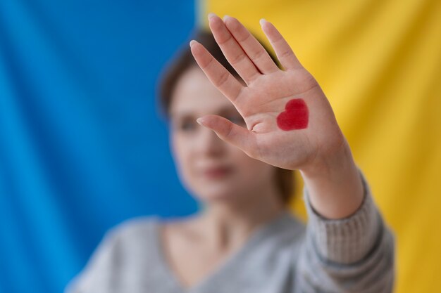 Blurry woman with ukrainian flag behind