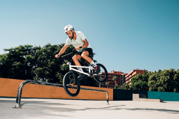 Bmx rider performing tricks in skatepark