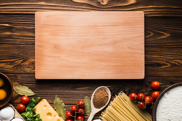 Board near ingredients for pasta