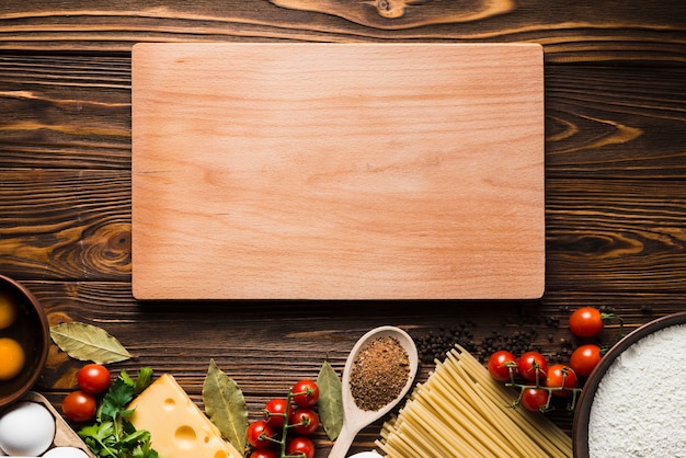 Board near ingredients for pasta