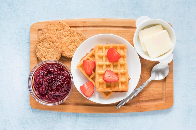 Board with waffles and fruits for breakfast