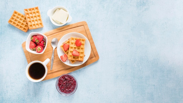 Board with waffles and fruits with copy-space