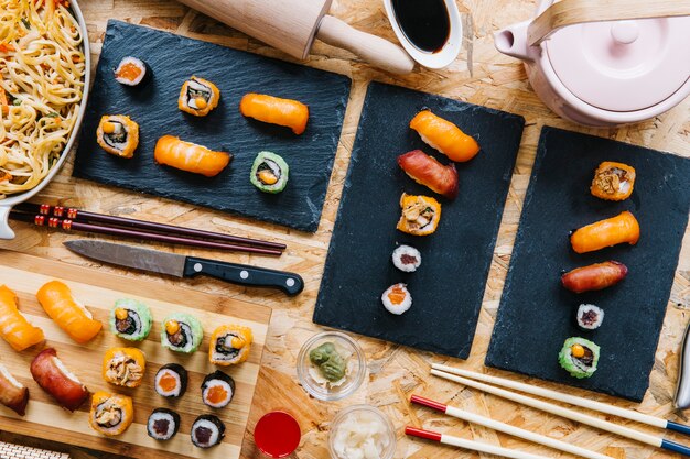 Boards with sushi on wooden tabletop