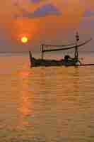Free photo boat fishing at the sunset
