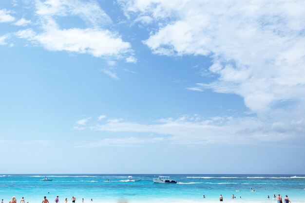 Boat goes in blue sea under deep blue sky