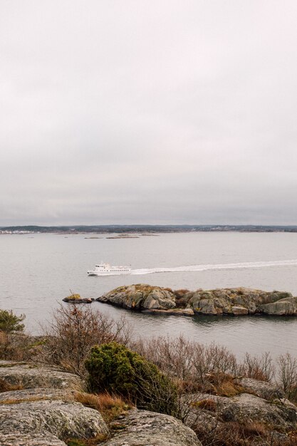 Boat sailing on the sea under cloudy sky