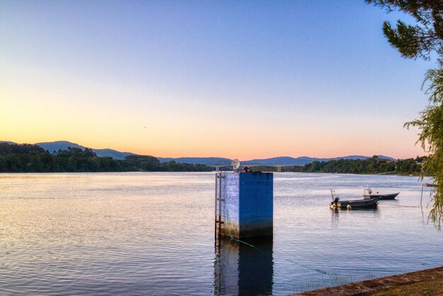 Boats on the calm sea under the pink and blue sky