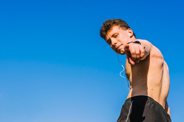 Body builder pointing at the camera