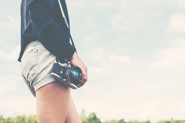 Body of a girl with a camera reflex