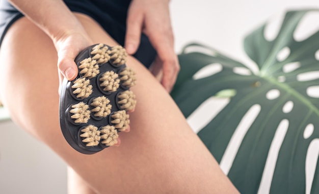 Free photo body massage brush in female hands on a blurred background