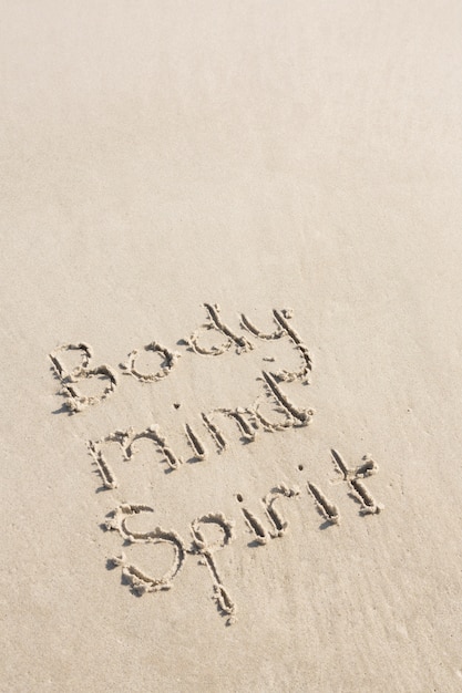 Free photo body mind spirit written on sand