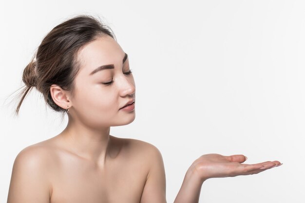 Body skincare care beauty asian woman showing product on side with open hand presenting and displaying isolated on white wall.