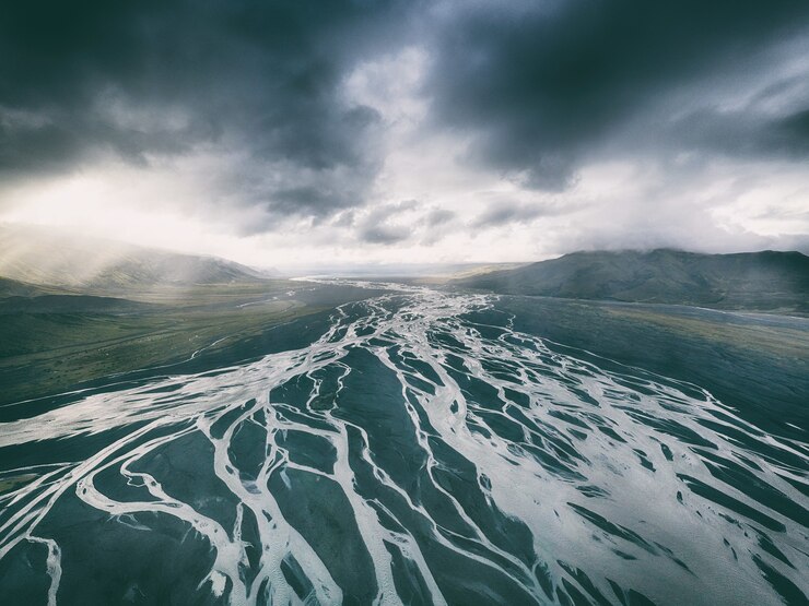 Body of water under black sky