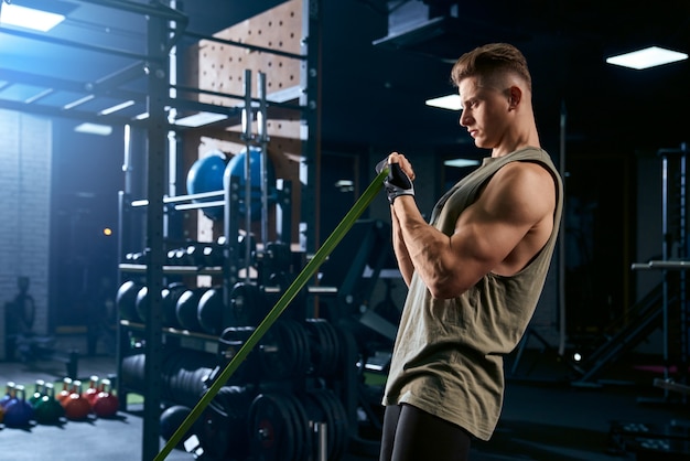 Bodybuilder training arm with resistance band.