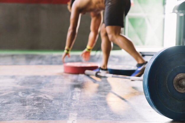 Bodybuilding concept with man taking weight plates